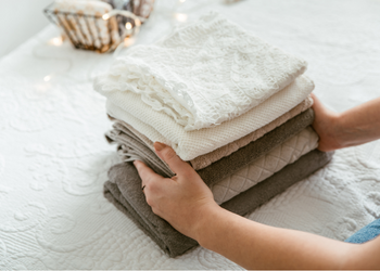 Photo of woman folding laundry